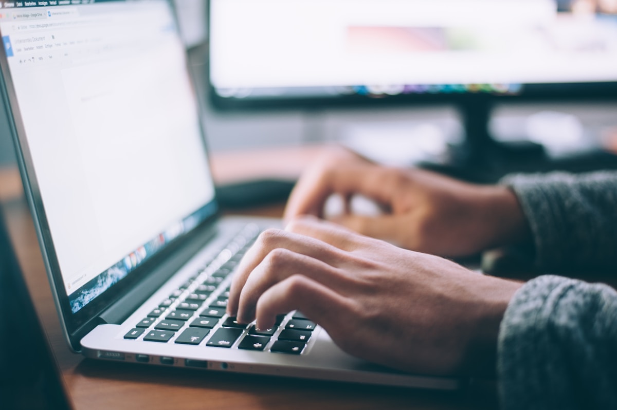 Hands typing on a laptop during a quiet morning work session